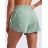 imageCRZ YOGA Womens High Waisted Running Shorts Mesh Liner 3 Dolphin Quick Dry for Athletic Gym Track Workout with Zip PocketGreen Palm Court