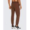 imageCRZ YOGA Athletic Joggers for Men Lightweight Water Resistant Outdoor Workout Pants with Zip PocketsDark Brown