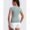 imageCRZ YOGA Seamless Workout Tops for Women Hip Length  Athletic Running Gym Yoga Short Sleeve Shirts Breathable Crewneck TeesGreen Palm Court