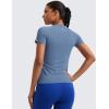 imageCRZ YOGA Seamless Workout Tops for Women Hip Length  Athletic Running Gym Yoga Short Sleeve Shirts Breathable Crewneck TeesOasis Blue